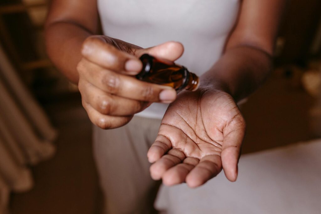 putting skincare oil on hands