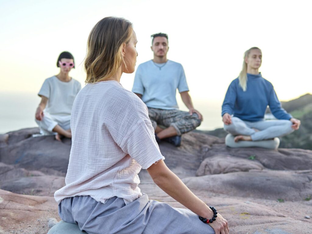 people meditating outdoors
